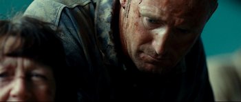 Movie still from “The Impossible” (2012), directed by J.A. Bayona – A person with blood on his face; Close Up shot, Over the shoulder angle