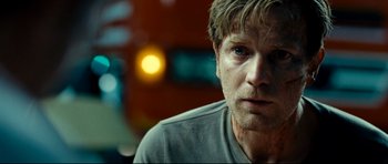 Movie still from “The Impossible” (2012), directed by J.A. Bayona – A person wearing a gray t - shirt; Close Up shot, Over the shoulder angle