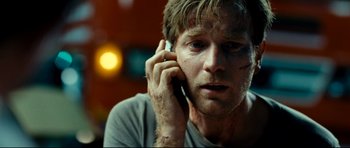 Movie still from “The Impossible” (2012), directed by J.A. Bayona – A person talking on a cell phone; Close Up shot, Low angle