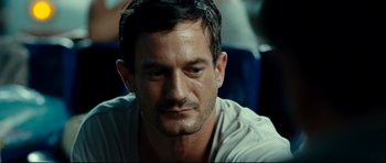 Movie still from “The Impossible” (2012), directed by J.A. Bayona – A person sitting down; Close Up shot, Over the shoulder angle