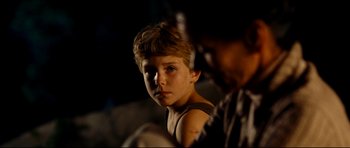 Movie still from “The Impossible” (2012), directed by J.A. Bayona – A young boy is looking into the camera; Close Up shot, Over the shoulder angle