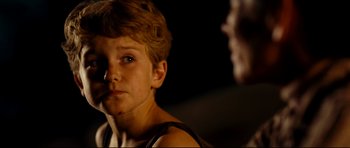 Movie still from “The Impossible” (2012), directed by J.A. Bayona – A young boy is looking into the distance; Close Up shot, Over the shoulder angle