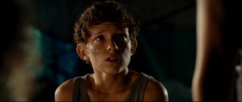 Movie still from “The Impossible” (2012), directed by J.A. Bayona – A young boy with a messy hair style looking up; Close Up shot, Over the shoulder angle