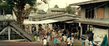 Movie still from “The Impossible” (2012), directed by J.A. Bayona – A group of people standing outside of a building; Extreme Wide shot, High angle