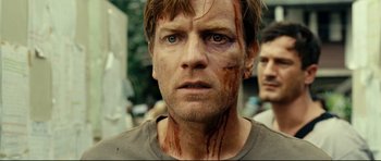 Movie still from “The Impossible” (2012), directed by J.A. Bayona – A person with blood all over his face; Close Up shot, Over the shoulder angle