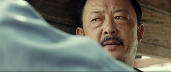 Movie still from “The Impossible” (2012), directed by J.A. Bayona – A person with a mustache; Close Up shot, Over the shoulder angle