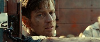 Movie still from “The Impossible” (2012), directed by J.A. Bayona – A man's face with a lot of dirt on his face; Close Up shot, Over the shoulder angle