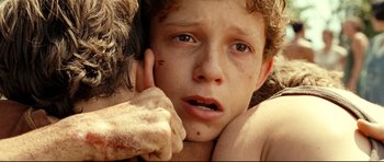 Movie still from “The Impossible” (2012), directed by J.A. Bayona – A person with a hand on his face; Close Up shot, Low angle