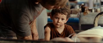 Movie still from “The Impossible” (2012), directed by J.A. Bayona – A young boy looking at an older man; Close Up shot, Over the shoulder angle