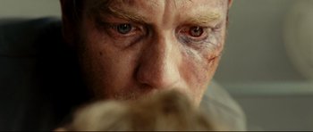 Movie still from “The Impossible” (2012), directed by J.A. Bayona – A man's eyes and face; Extreme Close Up shot, Over the shoulder angle