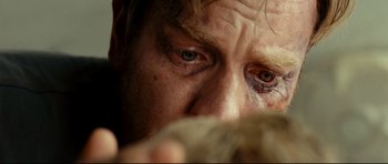 Movie still from “The Impossible” (2012), directed by J.A. Bayona – A man's eyes and face; Extreme Close Up shot, Overhead angle