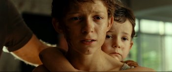 Movie still from “The Impossible” (2012), directed by J.A. Bayona – Two young boys are looking into the camera; Close Up shot, Low angle