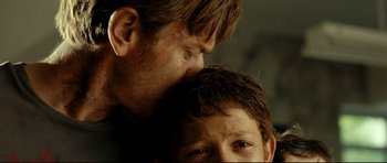 Movie still from “The Impossible” (2012), directed by J.A. Bayona – A person and a child's face; Close Up shot, Over the shoulder angle