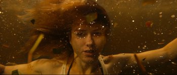 Movie still from “The Impossible” (2012), directed by J.A. Bayona – A woman with red hair is looking at the camera; Close Up shot, Overhead angle