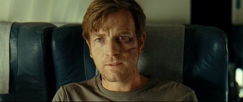 Movie still from “The Impossible” (2012), directed by J.A. Bayona – A person with a bruise on his face; Close Up shot, Over the shoulder angle