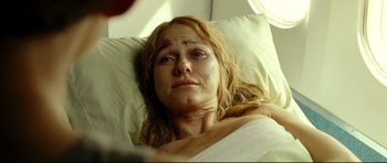 Movie still from “The Impossible” (2012), directed by J.A. Bayona – A woman laying in a hospital bed looking sad; Close Up shot, Over the shoulder angle