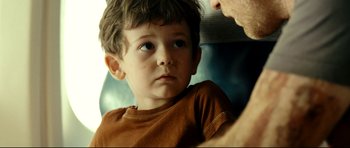Movie still from “The Impossible” (2012), directed by J.A. Bayona – A little boy sitting next to an older man; Close Up shot, Over the shoulder angle