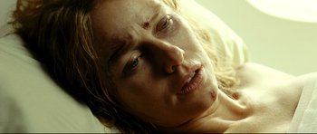 Movie still from “The Impossible” (2012), directed by J.A. Bayona – A person laying on a bed; Close Up shot, Overhead angle