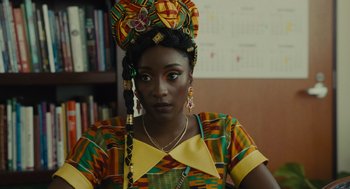 A woman in a colorful dress and a head dress