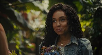 A woman holding a bouquet of flowers in her hands