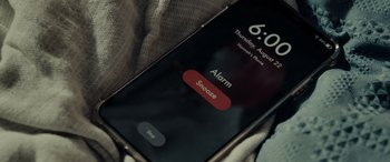 Movie still from “Appendage” (2023), directed by Anna Zlokovic – An alarm is displayed on a smart phone screen; Extreme Close Up shot, High angle