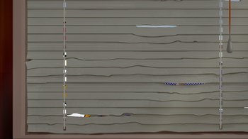 Movie still from “Aqua Teen Forever: Plantasm” (2022), directed by Dave Willis – A gray wall with a strip of paper on it; Extreme Wide shot, Low angle