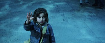 Movie still from “Aquaman” (2018), directed by James Wan – A young child standing in front of a wall; Medium shot, High angle