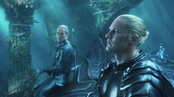 Movie still from “Aquaman” (2018), directed by James Wan – Two men sitting on a boat in the middle of the ocean; Medium shot, Over the shoulder angle