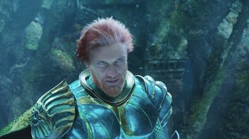 Movie still from “Aquaman” (2018), directed by James Wan – A person with a beard wearing armor; Medium shot, Low angle