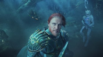 Movie still from “Aquaman” (2018), directed by James Wan – An image of a man with a sword in the water; Close Up shot, High angle