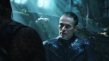 Movie still from “Aquaman” (2018), directed by James Wan – A person wearing a costume; Close Up shot, Over the shoulder angle