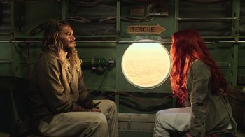 Movie still from “Aquaman” (2018), directed by James Wan – A man and a woman sitting in a room; Wide shot, Over the shoulder angle