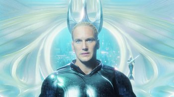 Movie still from “Aquaman” (2018), directed by James Wan – A man in a shiny black suit with horns on his head; Close Up shot, Low angle