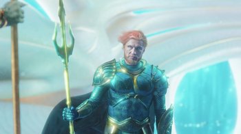 Movie still from “Aquaman” (2018), directed by James Wan – An image of a man with a red hair holding a spear; Medium shot, Over the shoulder angle