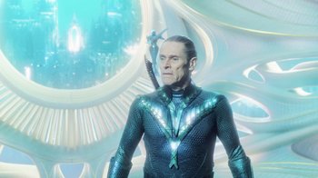 Movie still from “Aquaman” (2018), directed by James Wan – A man in a blue suit with a sword; Medium shot, Low angle