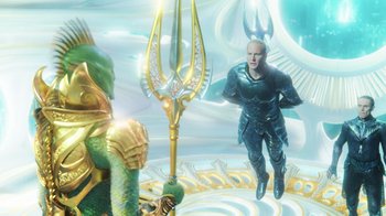 Movie still from “Aquaman” (2018), directed by James Wan – An image of a man with a trident in the background; Wide shot, High angle