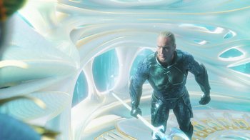 Movie still from “Aquaman” (2018), directed by James Wan – A man with a sword standing in an underwater tunnel; Wide shot, Low angle