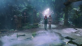 Movie still from “Aquaman” (2018), directed by James Wan – Two women are standing in the middle of a forest; Wide shot, High angle
