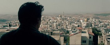 Movie still from “The Insider” (1999), directed by Michael Mann – A man looking out over a city from a high point; Medium shot, High angle