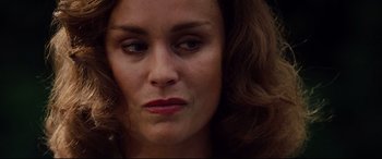 Movie still from “The Insider” (1999), directed by Michael Mann – A woman's face with red lipstick; Close Up shot, Over the shoulder angle