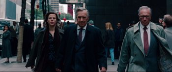 Movie still from “The Insider” (1999), directed by Michael Mann – An older man is walking down the street; Medium shot, Over the shoulder angle