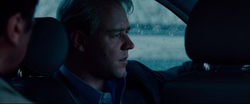 Movie still from “The Insider” (1999), directed by Michael Mann – A person in a car looking out the window; Close Up shot, Low angle