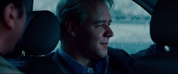 Movie still from “The Insider” (1999), directed by Michael Mann – A person sitting in a car; Close Up shot, Over the shoulder angle
