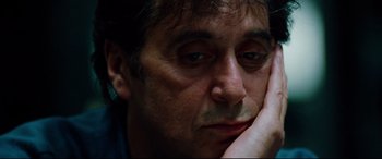 Movie still from “The Insider” (1999), directed by Michael Mann – A person with his hand under his chin; Close Up shot, High angle