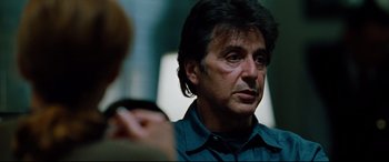 Movie still from “The Insider” (1999), directed by Michael Mann – A person talking to another person; Close Up shot, Over the shoulder angle