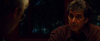 Movie still from “The Insider” (1999), directed by Michael Mann – A person sitting in a room; Close Up shot, Over the shoulder angle