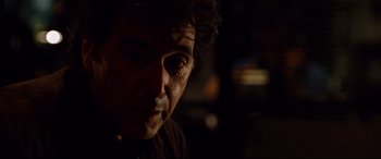 Movie still from “The Insider” (1999), directed by Michael Mann – A person with a black eye; Close Up shot, Over the shoulder angle