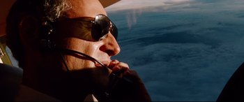 Movie still from “The Insider” (1999), directed by Michael Mann – A man wearing sunglasses and holding a cell phone to his ear; Close Up shot, Low angle