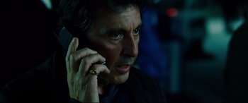 Movie still from “The Insider” (1999), directed by Michael Mann – A person talking on a cell phone; Close Up shot, Low angle