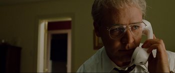 Movie still from “The Insider” (1999), directed by Michael Mann – A person wearing glasses and a tie; Close Up shot, Low angle